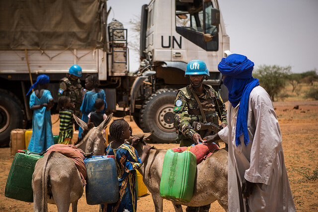 Peacekeepers serving with the UN Multidimensional Integrated Stabilization Mission in Mali (MINUSMA) carried out civil-military cooperation (CIMIC) activities with the local community in Gao, which included free medical consultations, distribution of drinking water, and mine-risk education on the dangers and identification of unexploded ordnance. | Photo by Harandane Dicko/UN Photo/flickr [CC BY-NC-ND 2.0] 